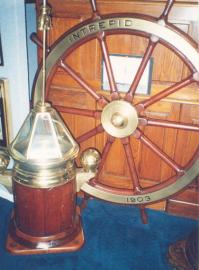 Wheel, Binnacle, and Photograph From Yacht INTREPID